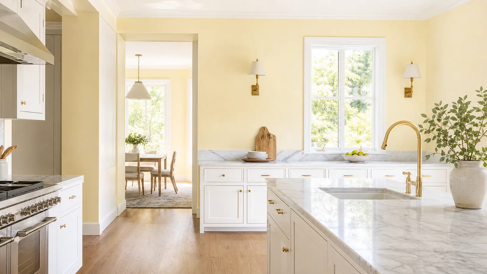 Lemon chiffon yellow kitchen with white cabinets and brass fixtures